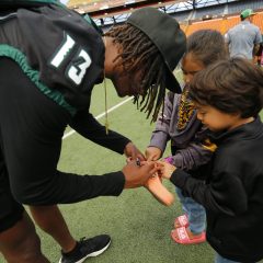UH football players signing autographs